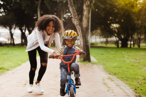 Mom teaching son to bike